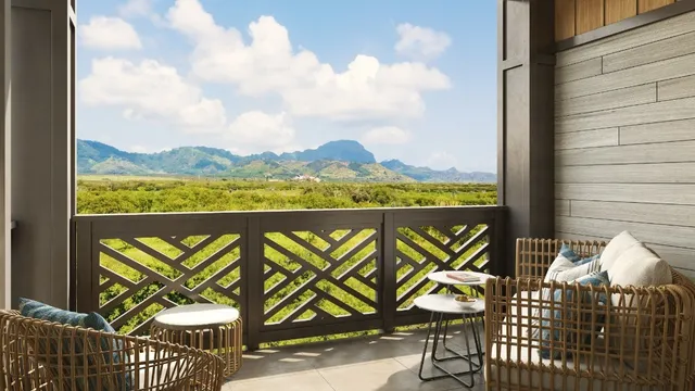 a view of a chairs and table in the balcony