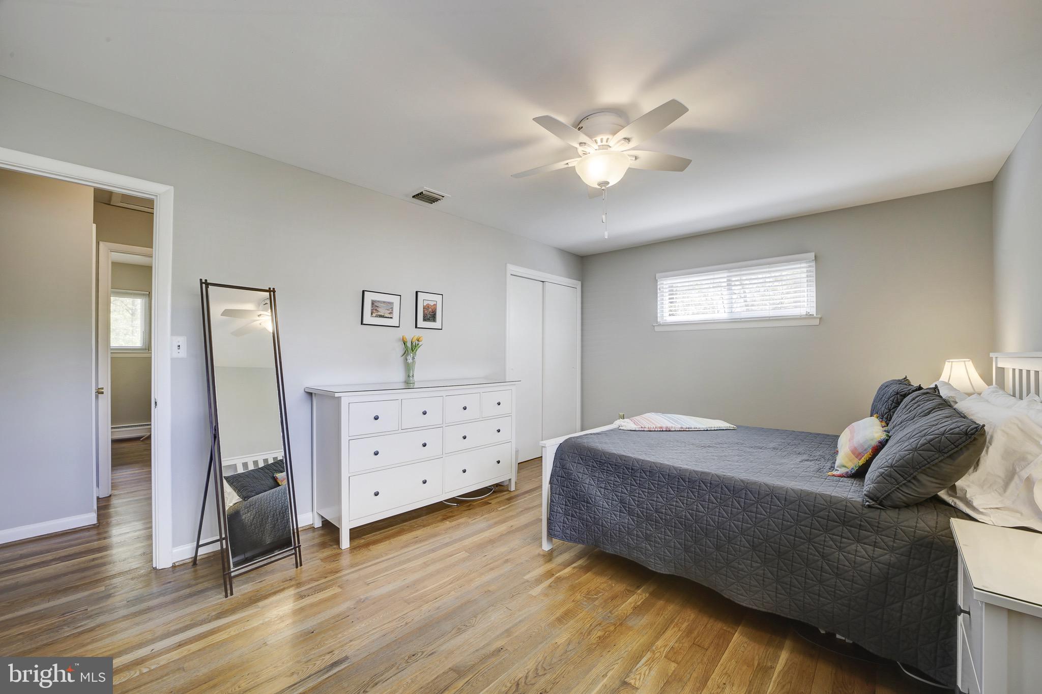 6326 Rockhurst Road Bethesda, MD 20817 - Photo 15 of 32 a bedroom with a bed and a chandelier