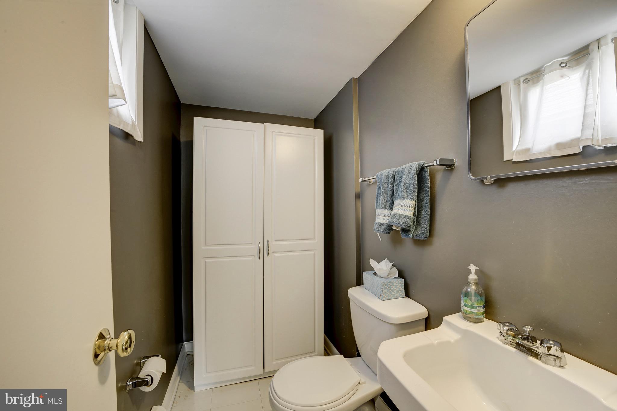 6326 Rockhurst Road Bethesda, MD 20817 - Photo 25 of 32 a bathroom with a toilet sink and mirror