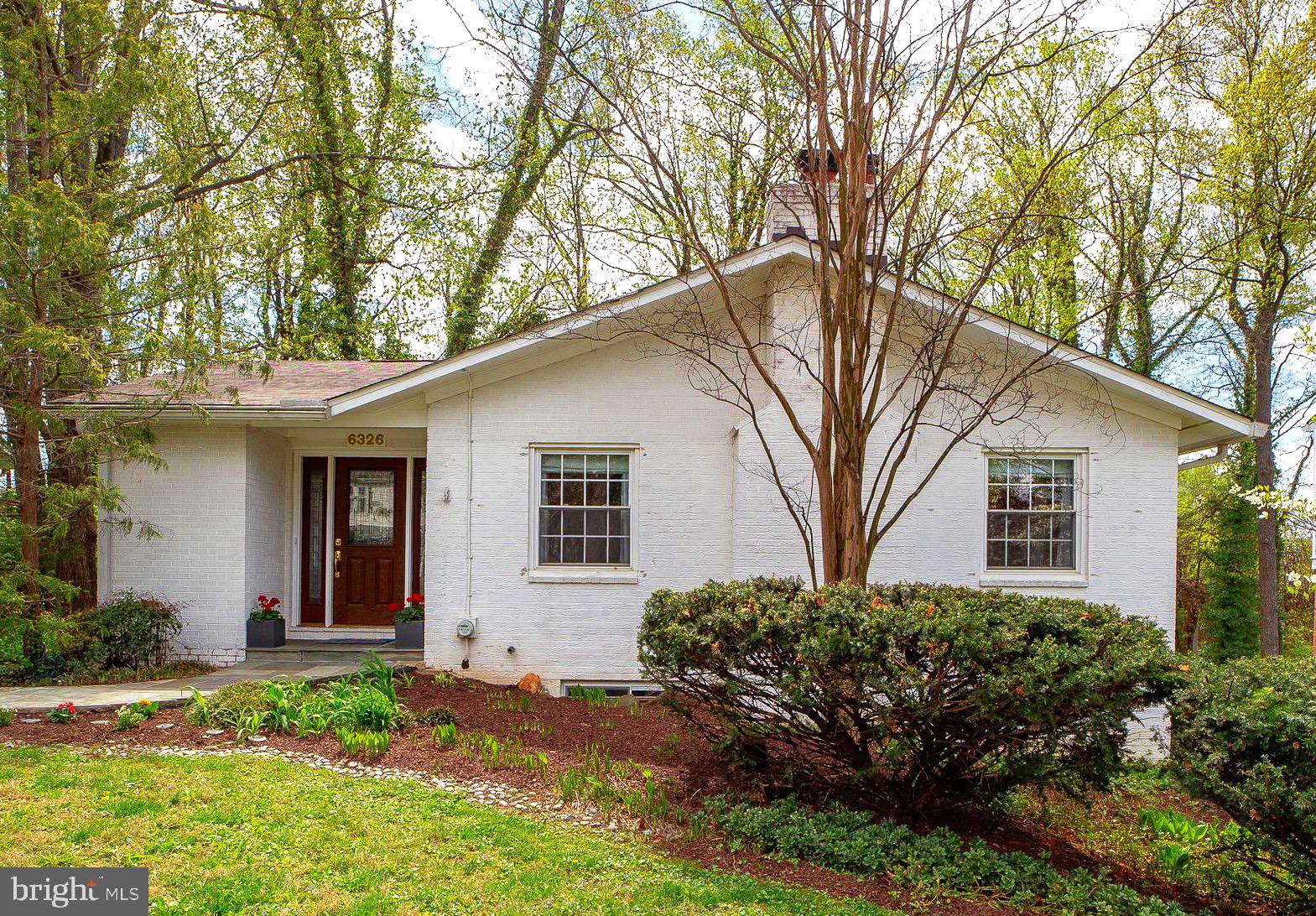 6326 Rockhurst Road Bethesda, MD 20817 - Photo 4 of 32 a front view of a house with a yard and garage