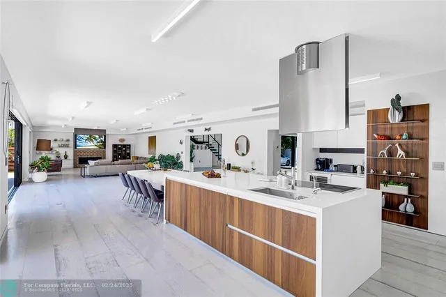 a large white kitchen with stainless steel appliances