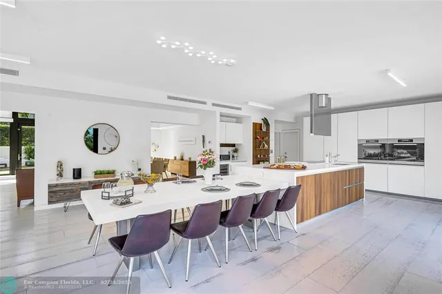 a large kitchen with a table and chairs