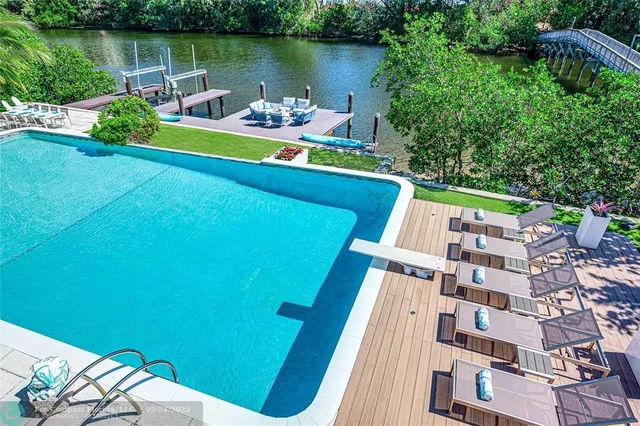 a view of a lake with couches chairs and a table