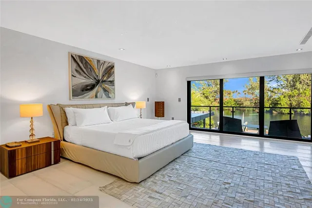 a spacious bedroom with a large bed and a large window