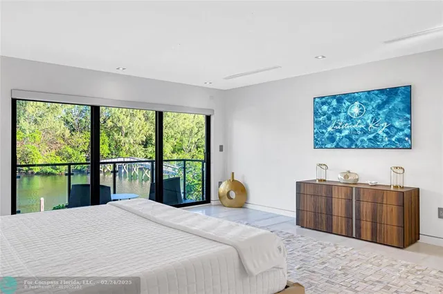 a bedroom with a large bed and a large window