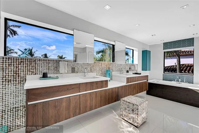 a large white kitchen with a large window