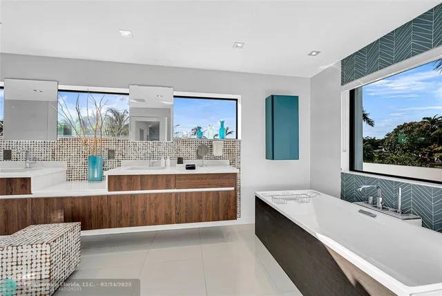 a large bathroom with a large tub sink and window