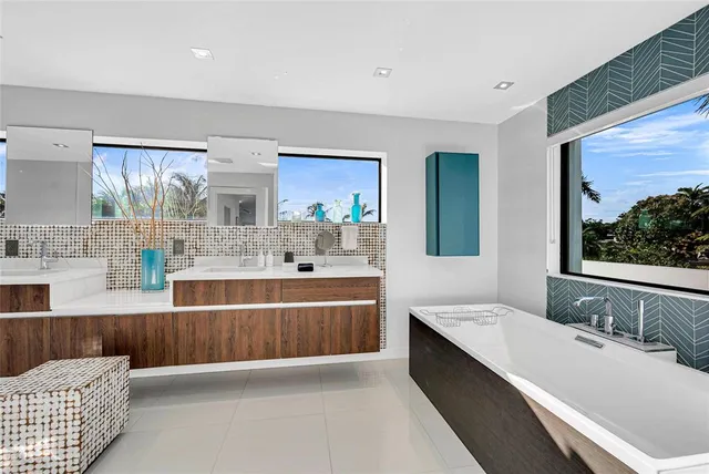 a large bathroom with a large tub sink and mirror