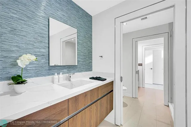 a bathroom with a sink a vanity and a mirror