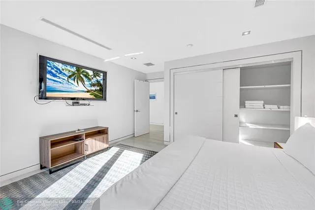 a bedroom with a bed and a view of kitchen