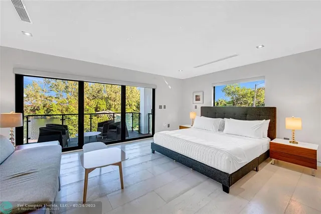 a spacious bedroom with a bed and a large window