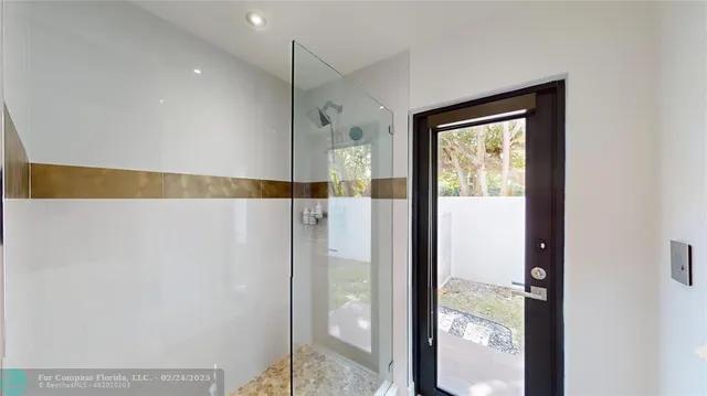 a bathroom with a shower and a bath tub