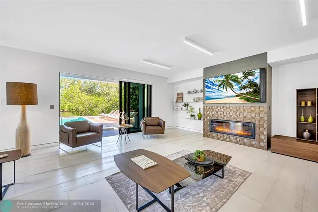 a living room with furniture a fireplace and a flat screen tv