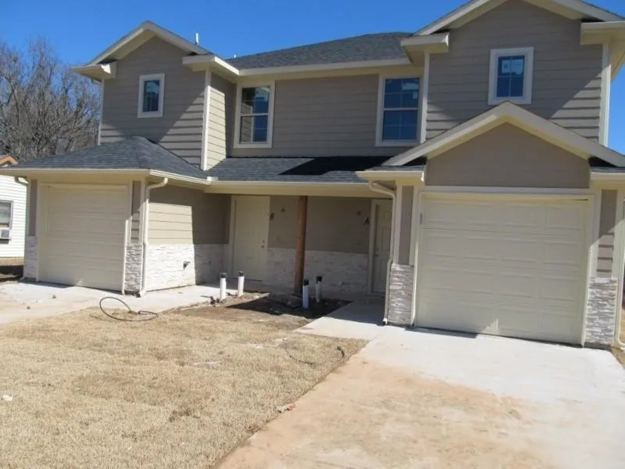 1525 Franklin Street Bonham, TX 75418 - Photo 2 of 6 a front view of a house with a yard and garage