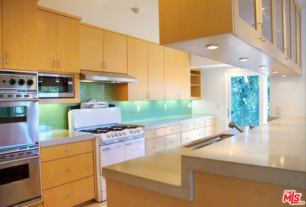 357 North Skyewiay Road Los Angeles, CA 90049 - Photo 11 of 21 a kitchen with a stove a sink and a cabinets