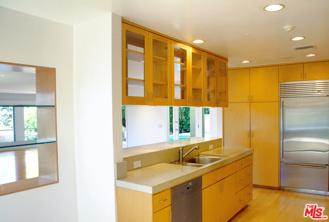 357 North Skyewiay Road Los Angeles, CA 90049 - Photo 12 of 21 a bathroom with a tub sink and a mirror