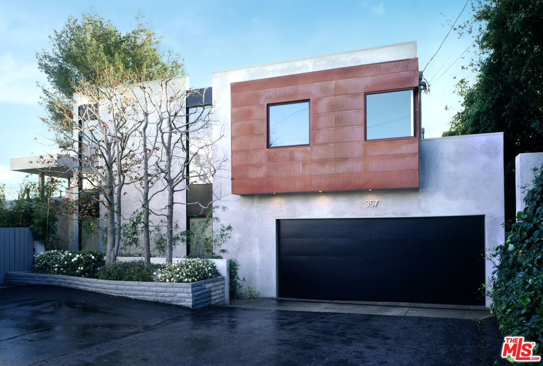 357 North Skyewiay Road Los Angeles, CA 90049 - Photo 7 of 21 a front view of a house with a yard