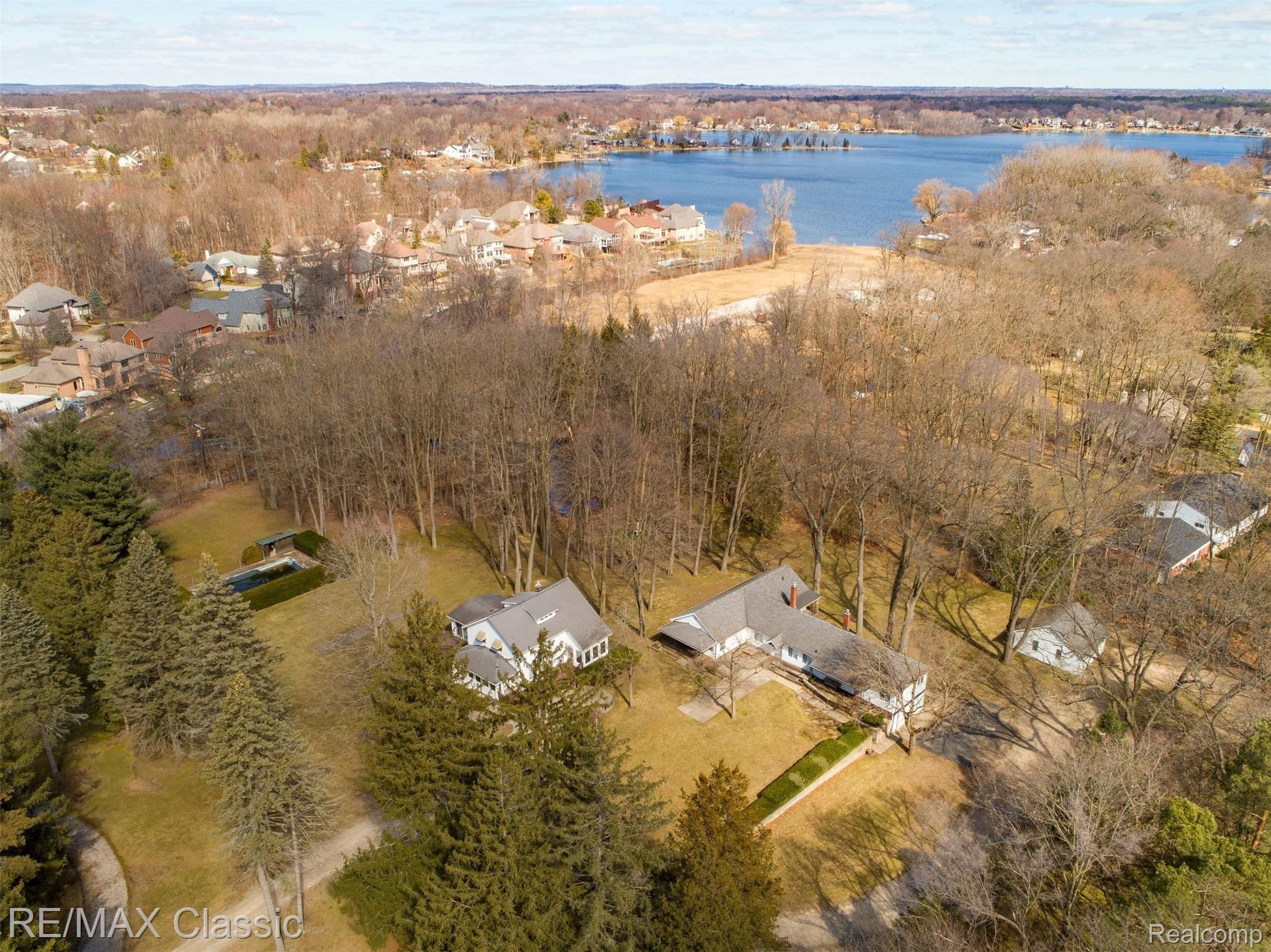 3980 Benstein Road Commerce Township, MI 48382 - Photo 8 of 68 Aerial view of the pool, farmhouse, ranch, detached garage, and canal on property leading to Commerce Lake.