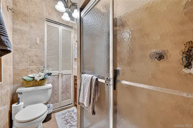 a bathroom with a toilet and a shower