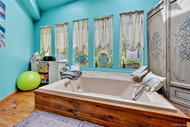 a bathroom with a bathtub and next to a window