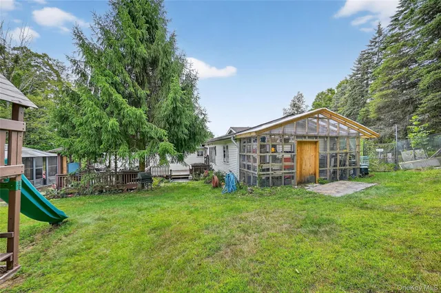 a view of a house with a yard and sitting area
