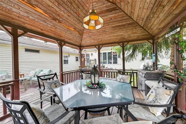 a view of patio with table and chairs and potted plants