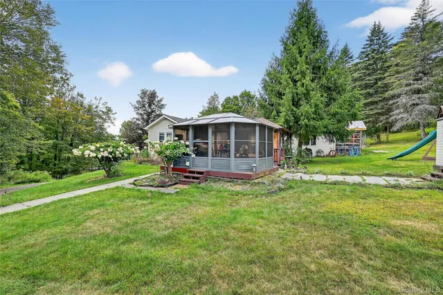 a view of a house with a yard porch and sitting area