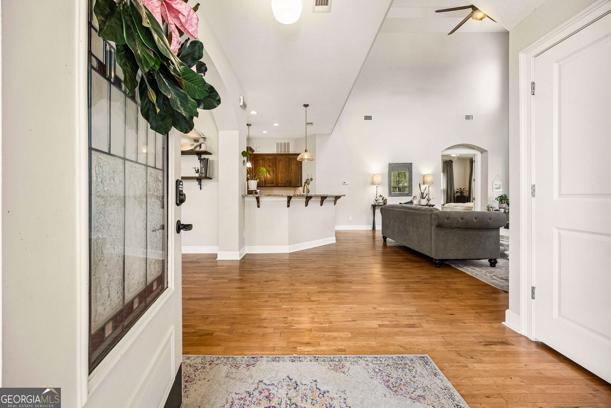 706 Hopewell Point Road White Oak, GA 31568 - Photo 3 of 84 Step inside to soaring ceilings, warm hardwood floors, and an inviting open-concept layout that immediately feels like home.