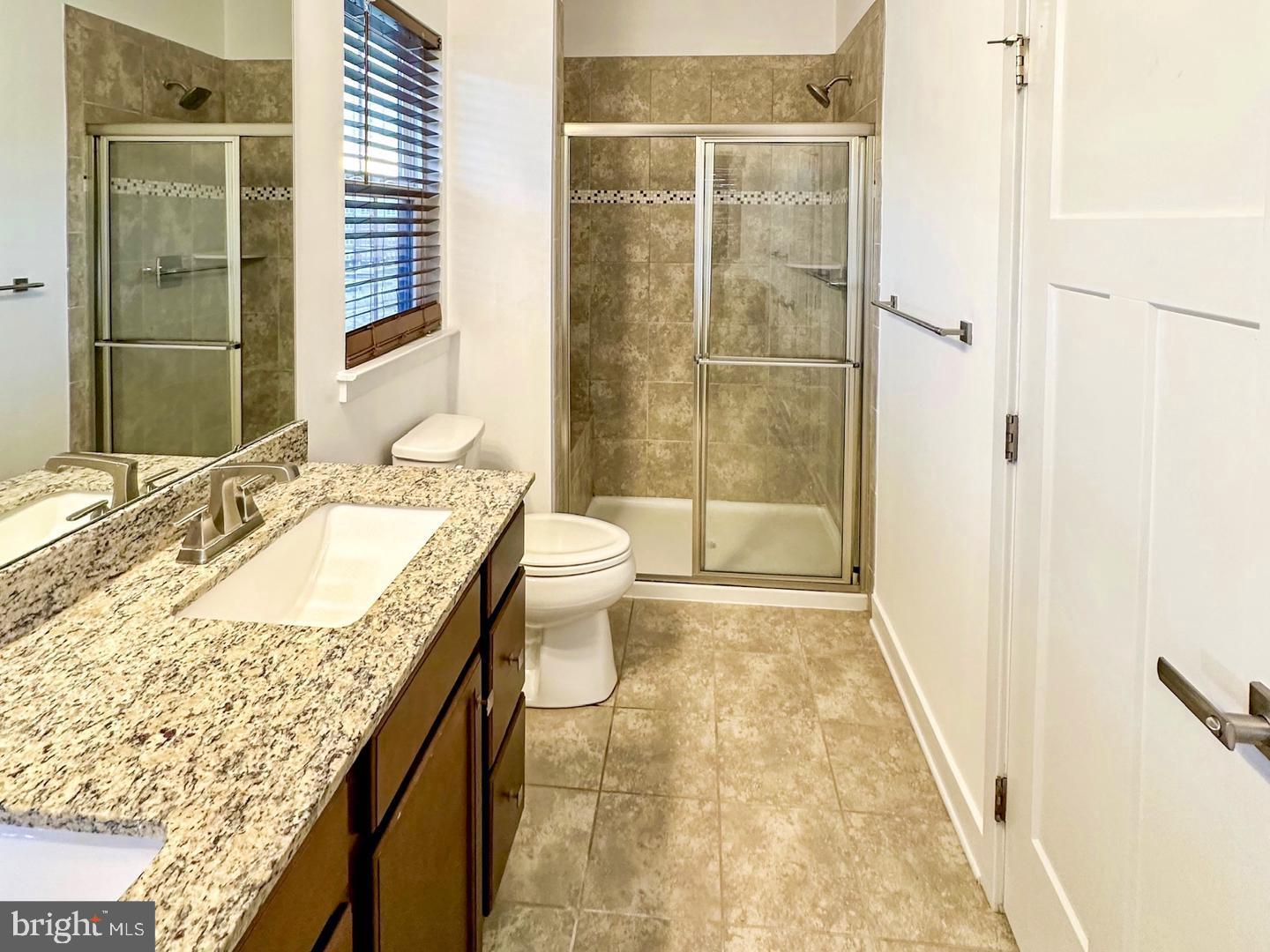 601 Colindale Street Middle River, MD 21220 - Photo 7 of 17 a bathroom with a granite countertop sink a toilet and shower