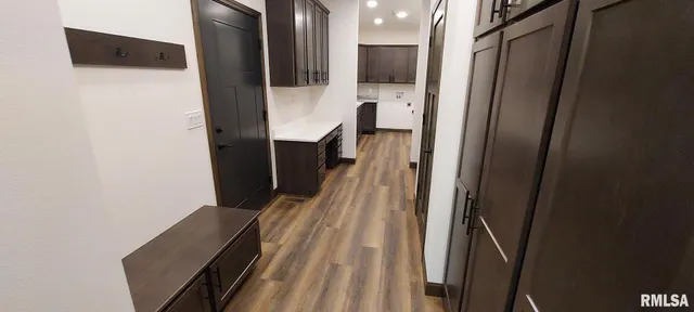 a view of a hallway with wooden floor and staircase