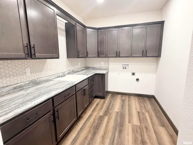 a kitchen with wooden cabinets and sink