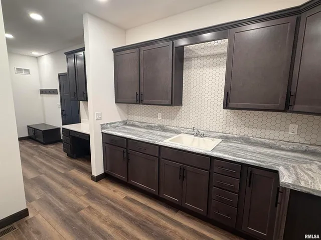 a bathroom with double vanity and a bathtub