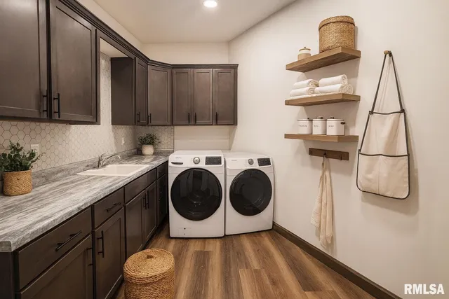 a utility room with sink dryer and washer