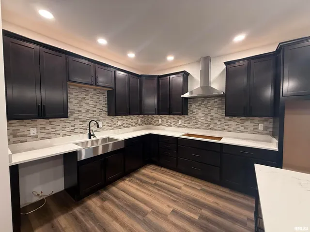 a kitchen with stainless steel appliances granite countertop wooden cabinets a refrigerator and a sink