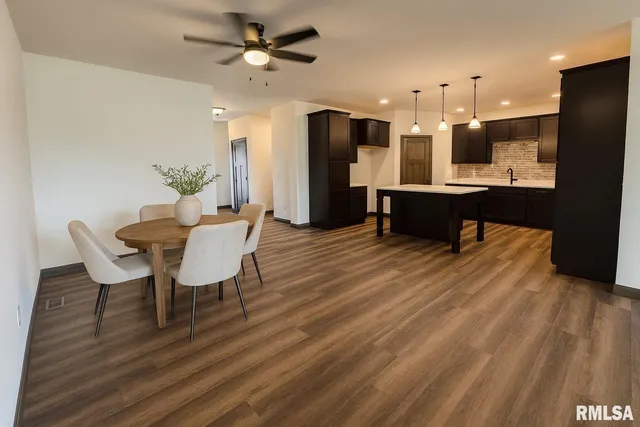 a view of a dining room with furniture and a wooden floor