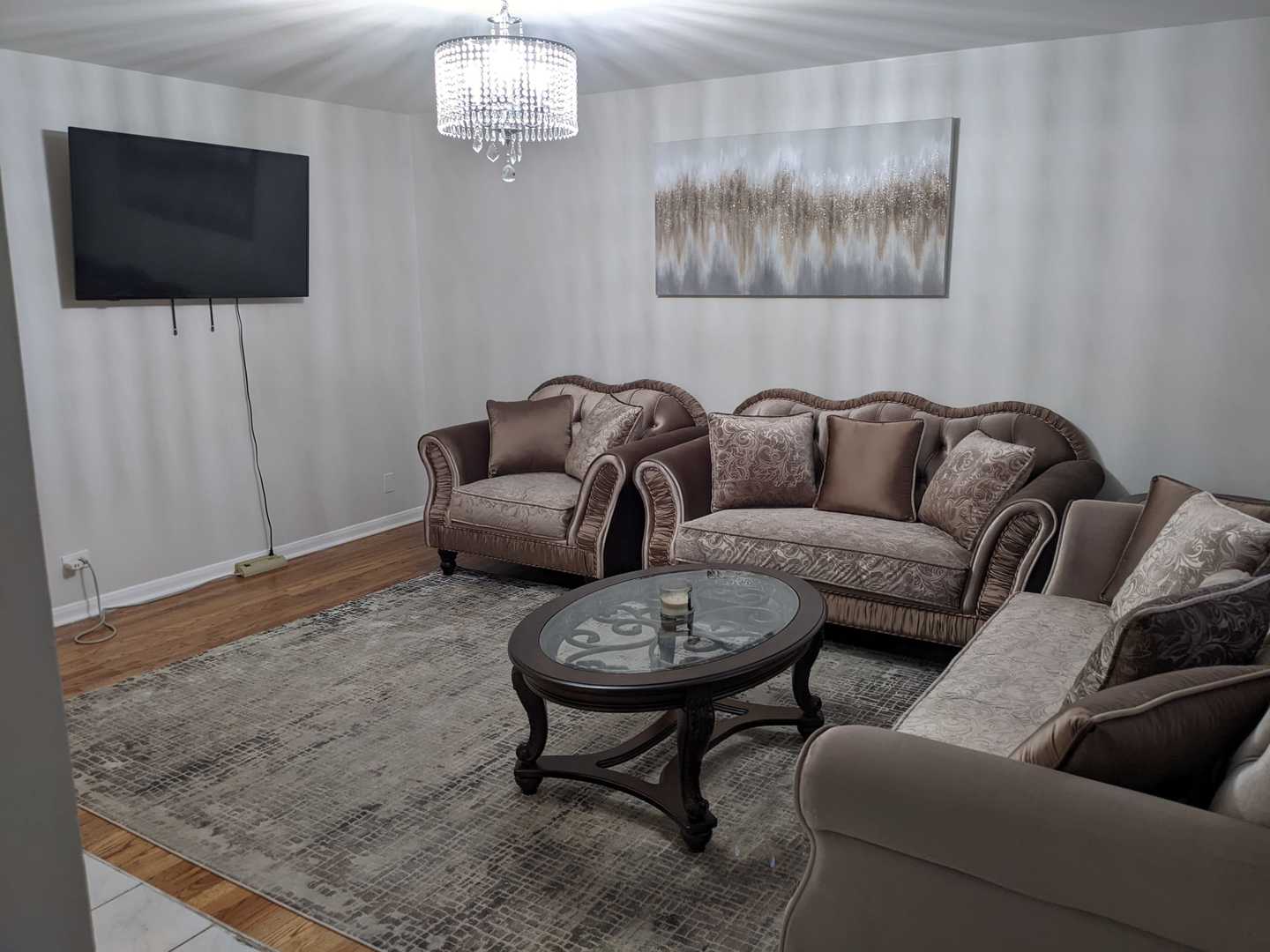 10015 Frontage Road, Unit B Skokie, IL 60077 - Photo 4 of 20 a living room with furniture and a flat screen tv