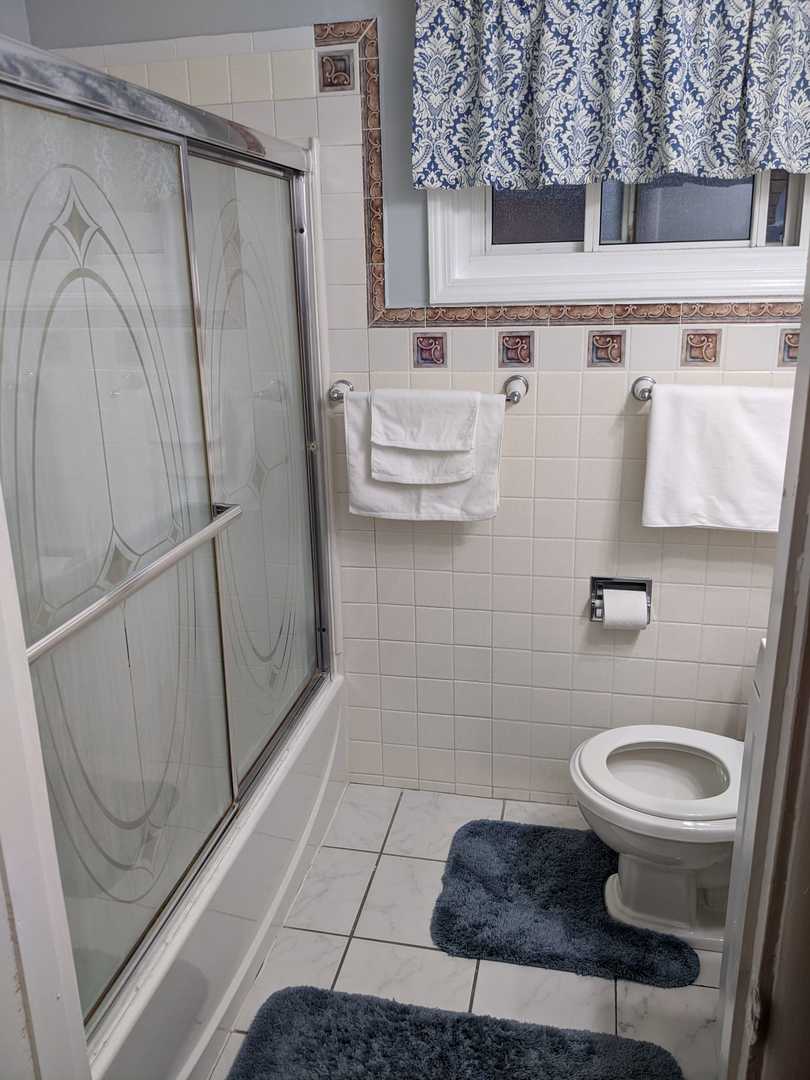 10015 Frontage Road, Unit B Skokie, IL 60077 - Photo 9 of 20 a bathroom with a sink a toilet and shower