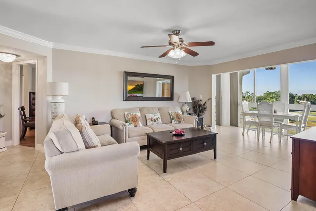 a living room with furniture and view of kitchen
