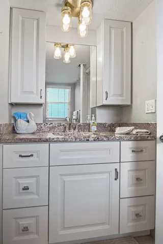 a kitchen with cabinets appliances and a sink