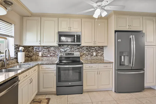 a kitchen with cabinets stainless steel appliances and a sink