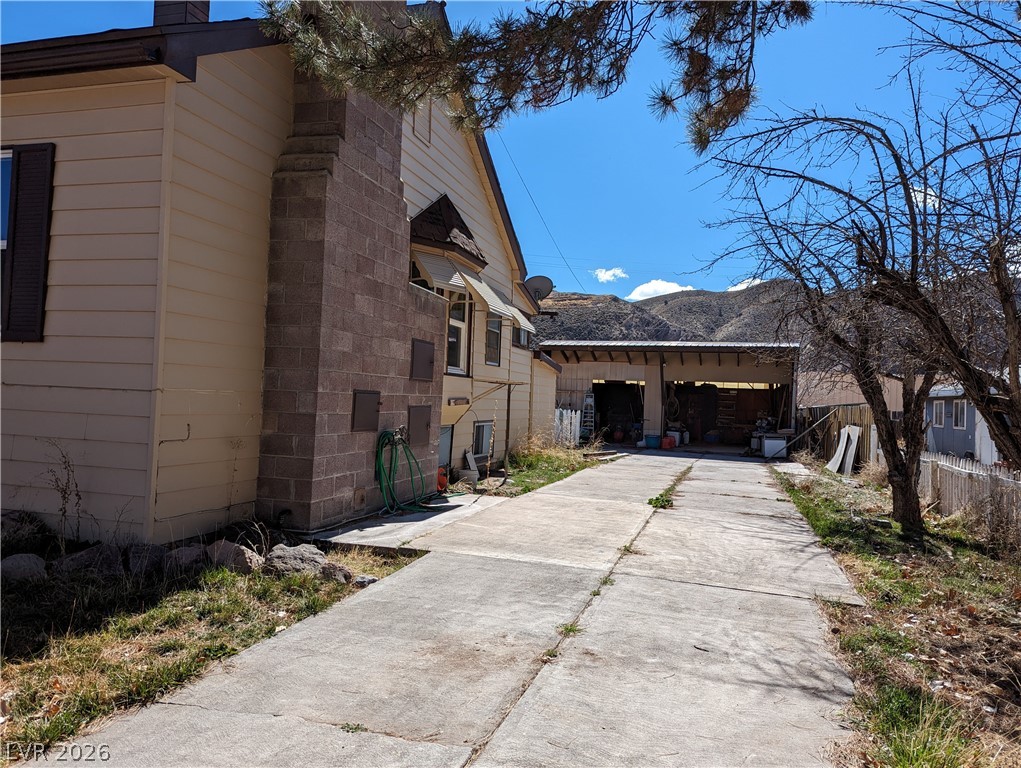 561 Main Street Caliente, NV 89008 - Photo 29 of 32 View of side of property with a mountain view and a chimney