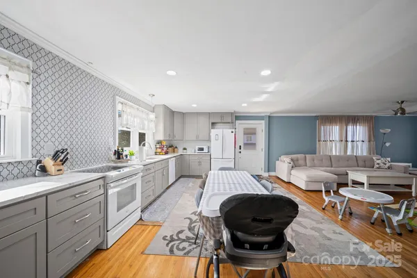 a large white kitchen with a large window