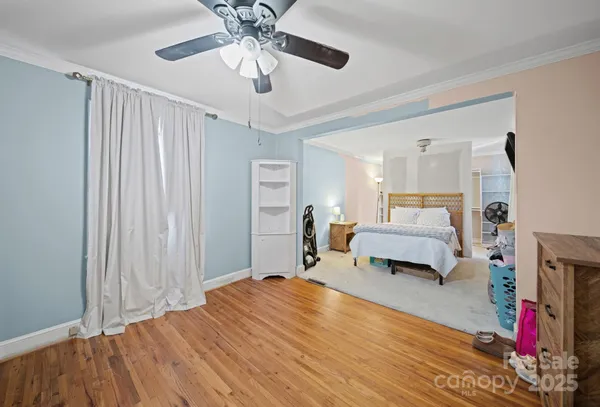 a bedroom with furniture and a wooden floor
