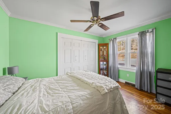 a bed sitting in a bedroom next to a window