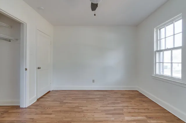 wooden floor in an empty room with a window