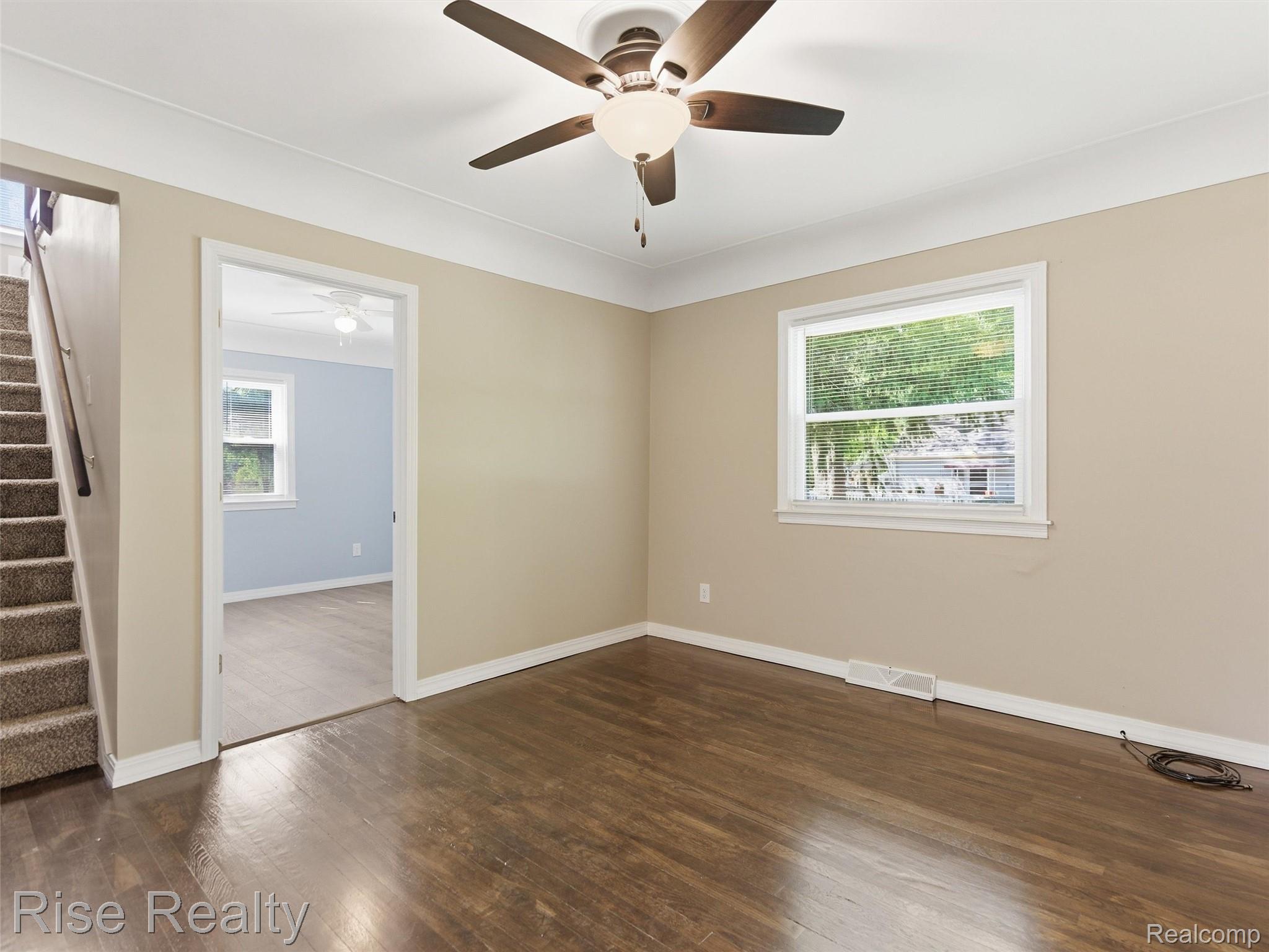 2449 North Genesee Road Burton, MI 48509 - Photo 19 of 40 Spacious room featuring wood-finish flooring, a ceiling fan with integrated lighting, and a window with white trim
