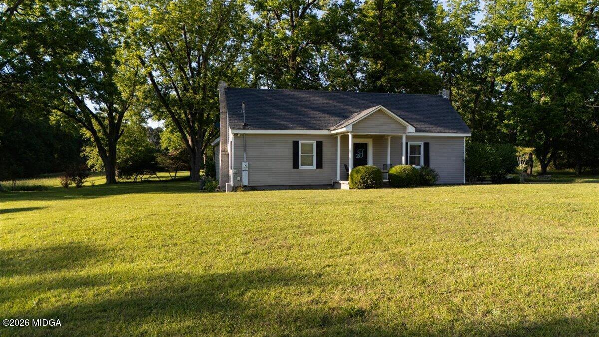 214 Howard Roberts Road Gray, GA 31032 - Photo 3 of 36 a front view of house with yard and trees in the background