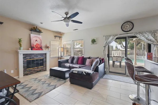 a living room with furniture a clock and a fireplace