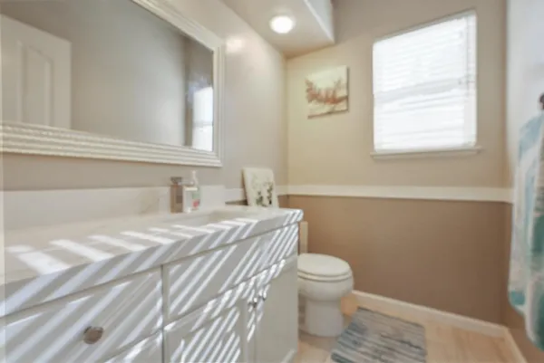 a bathroom with a toilet a sink and a window