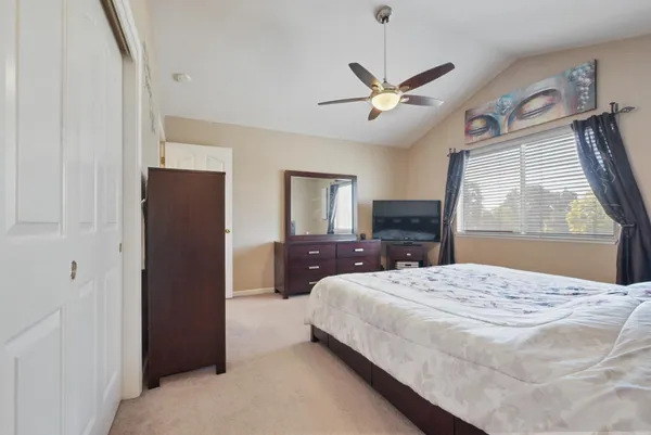 a bedroom with a large bed and a window